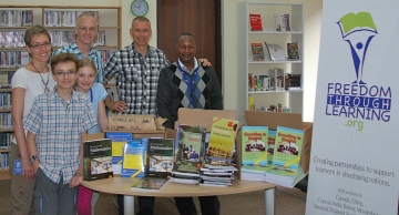 The Whall family, along with FTL co-founder Brian, present Kimuumo Secondary School visionary Peter Muthusi with the a set of textbooks for Form 1 & 2 (9th and 10th Grade) in the area of English, maths, Kiswahili and chemistry.